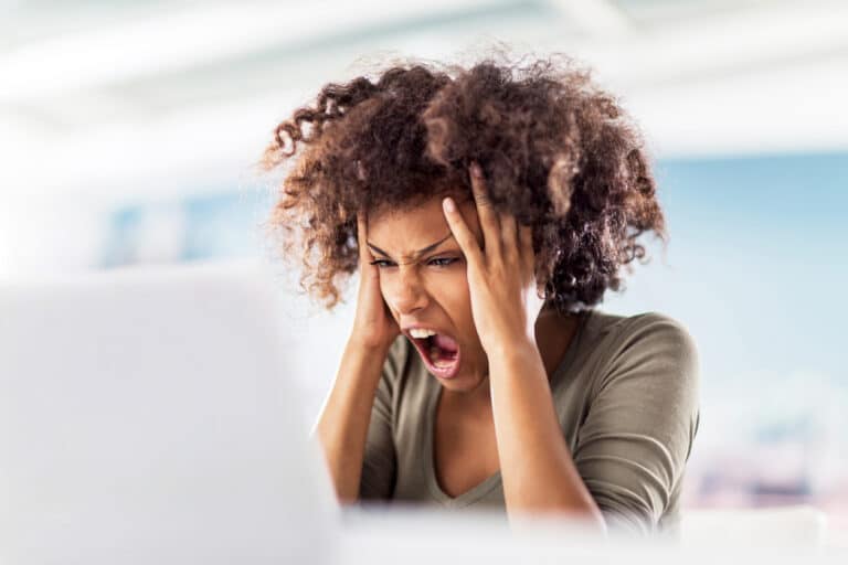 Angry woman using computer.