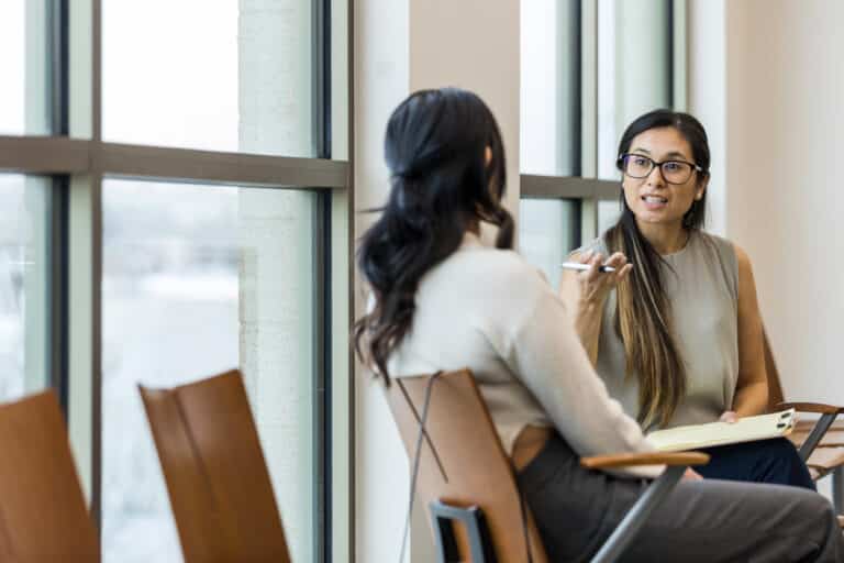 Female life coach helps unrecognizable female client by asking thought provoking questions