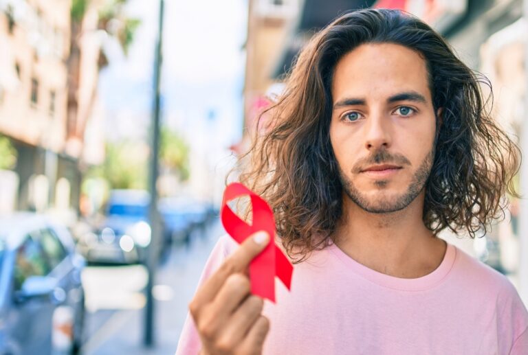 Young man with HIV/AIDS awareness ribbon