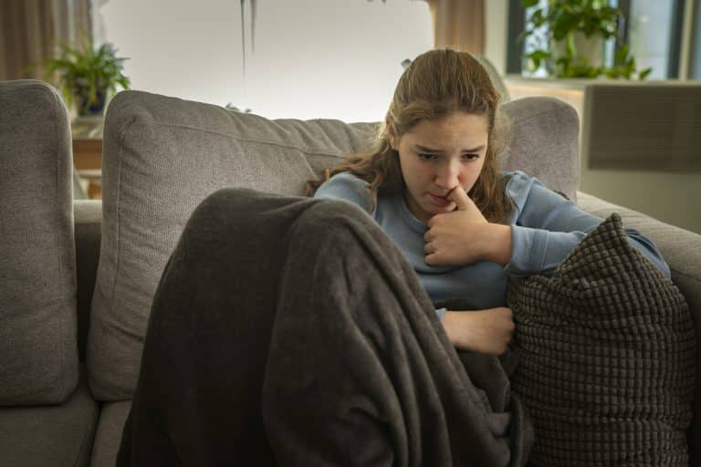 Anxious and nervous teenager girl biting her nails