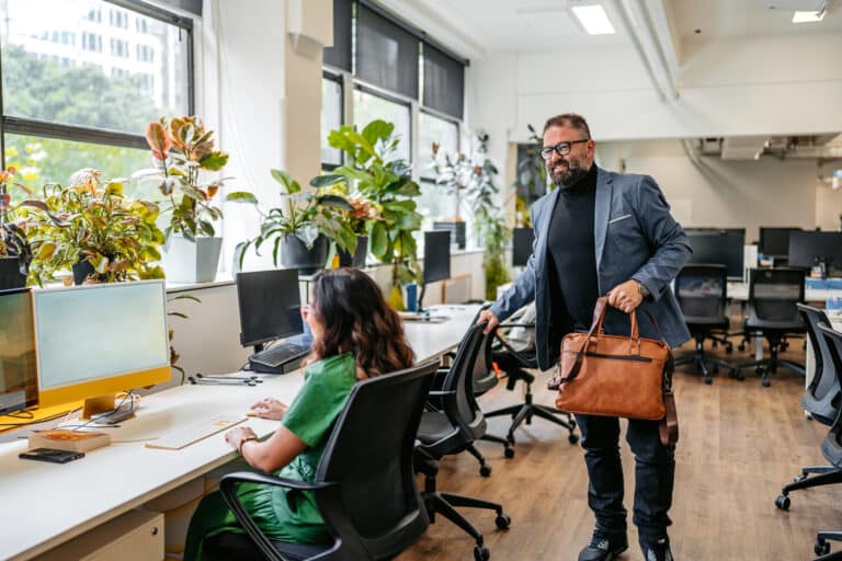 Adult leaving work happy because he is balancing is professional responsibility and personal wellbeing