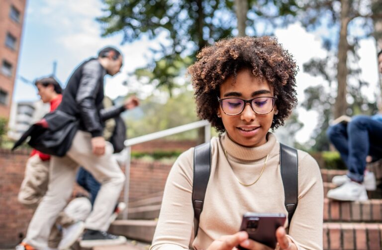 Young university students using social media while at campus