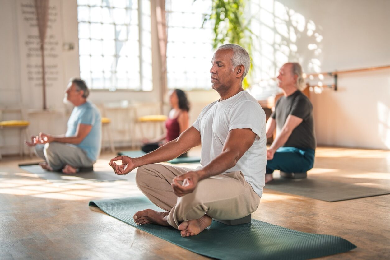 A diverse group of people practicsing mindfulness and meditation