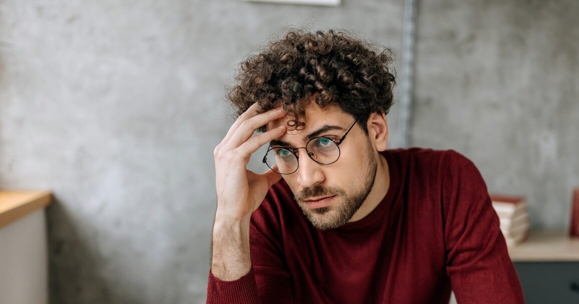 a male professional who is currently struggling with burnout