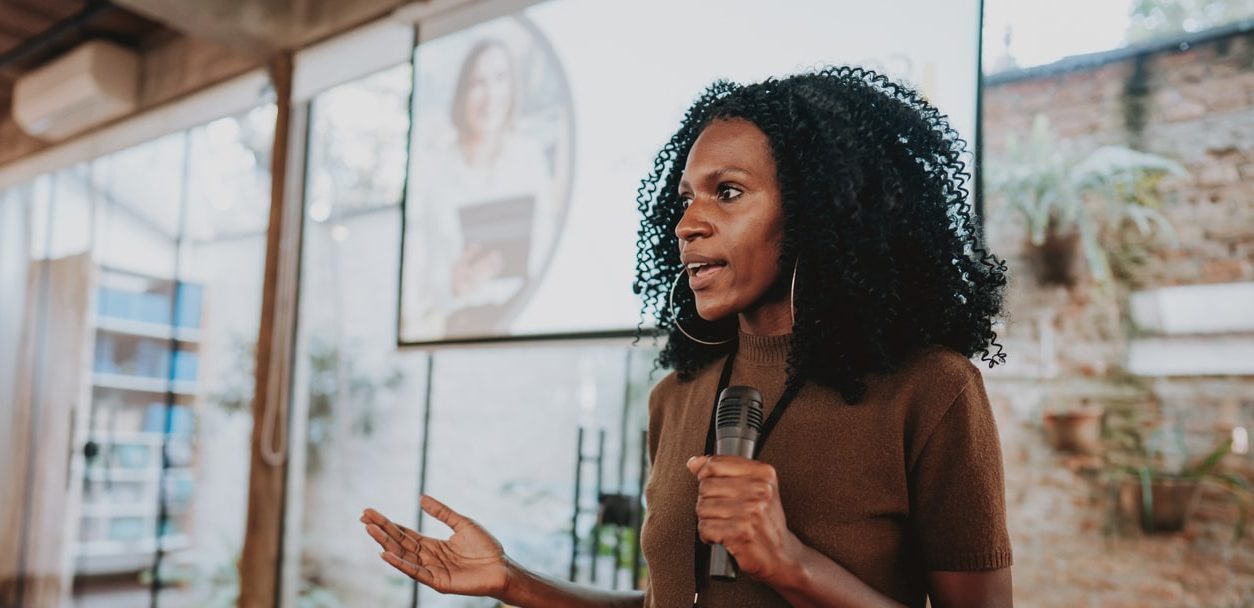 Woman giving speaker presentation on coaching