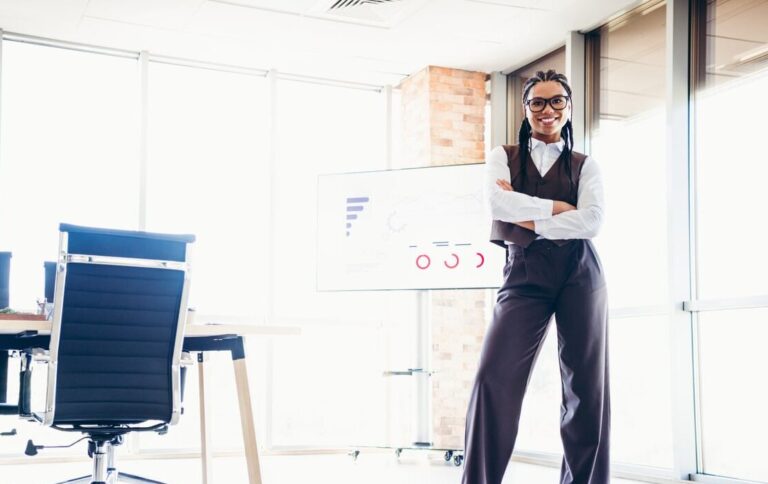 A young business woman who has learned how to overcome imposter syndrome and shows up confidently every day