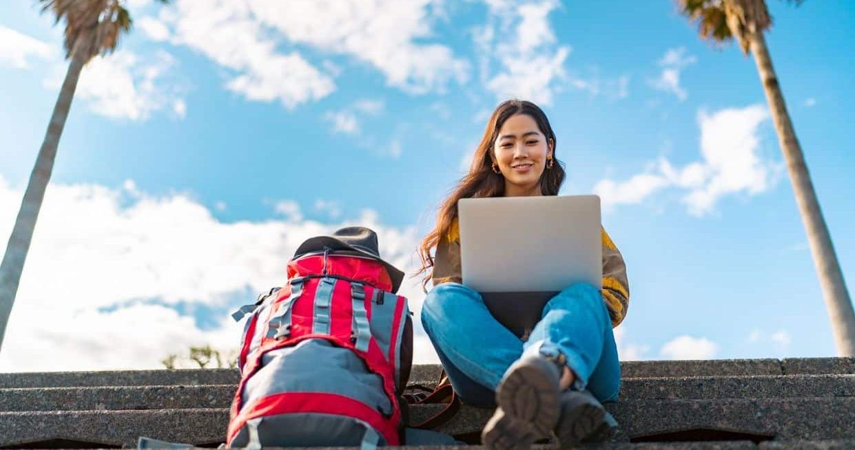 Young woman doing a short course online while traveling during her gap here