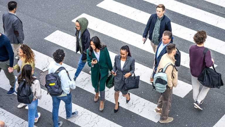 People crossing the street doing their daily tasks