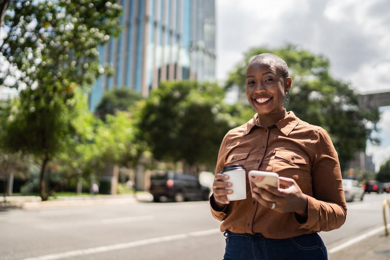 Young woman with positive self-esteem walking and smiling at camera.