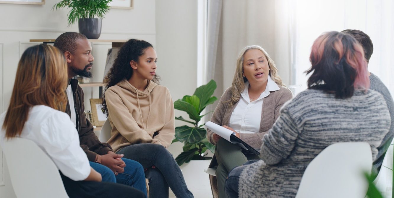 Counselling, group and psychology discussion with group of diverse people in therapy for addiction