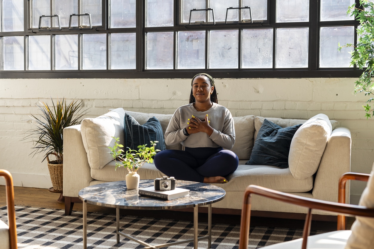 Young woman being mindful of her mental health and wellbeing by practicing self-compassion