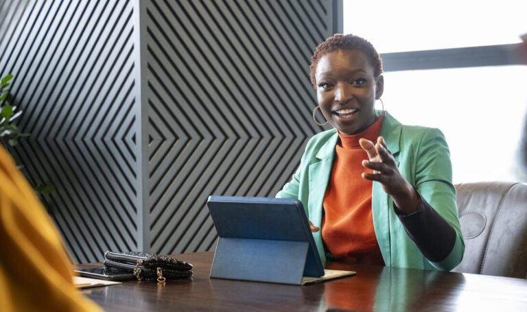 Business woman having a conversation with her team in a meeting
