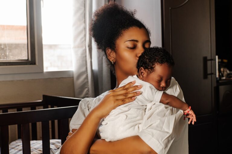 Young mother showing affection to her child after breastfeeding