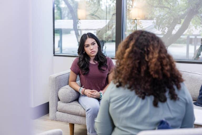 Young person struggling with their mental health and speaking to someone who can do mental health first aid