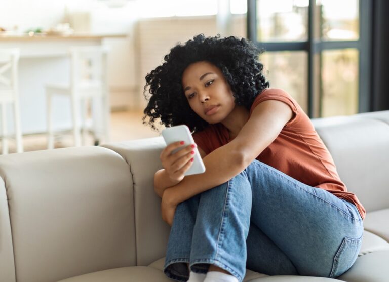 Young women scrolling social media and it's affecting her mental health