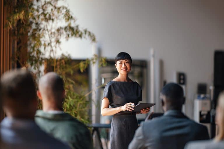 Business woman giving a presentation who has mastered communication skills for a successful career