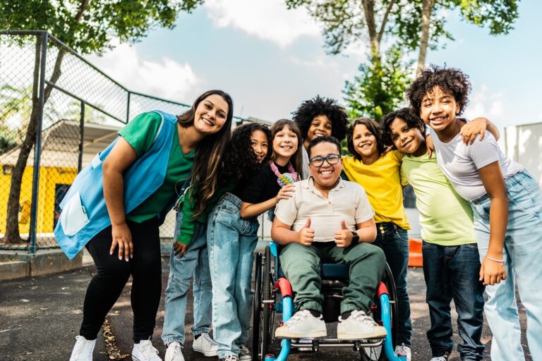 Group of happy children on the playground with an adult volunteer supervising