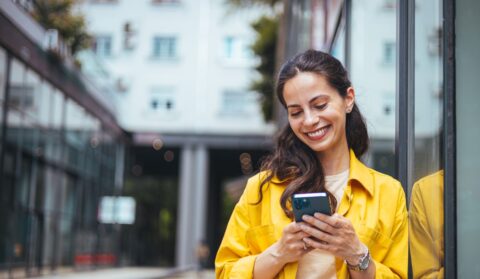 Young women engaging in a relationship through AI platforms on her phone