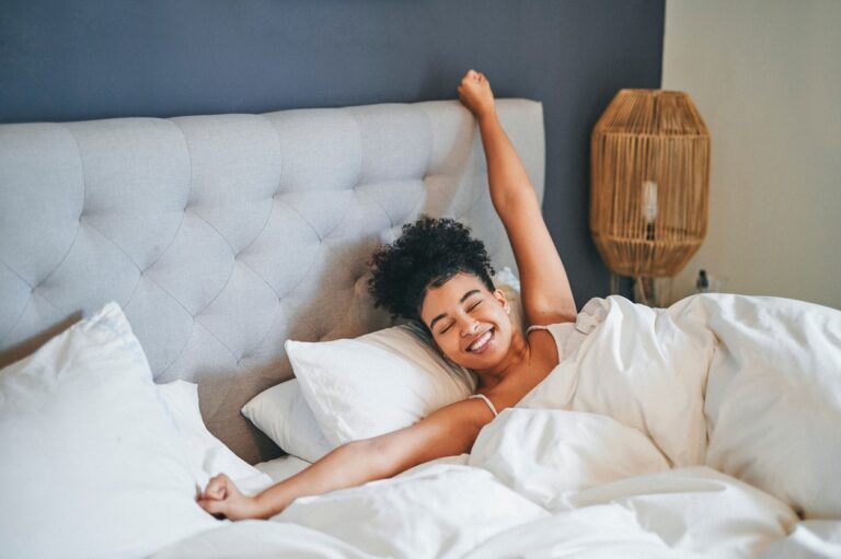 Young woman waking up after a good night of sleep