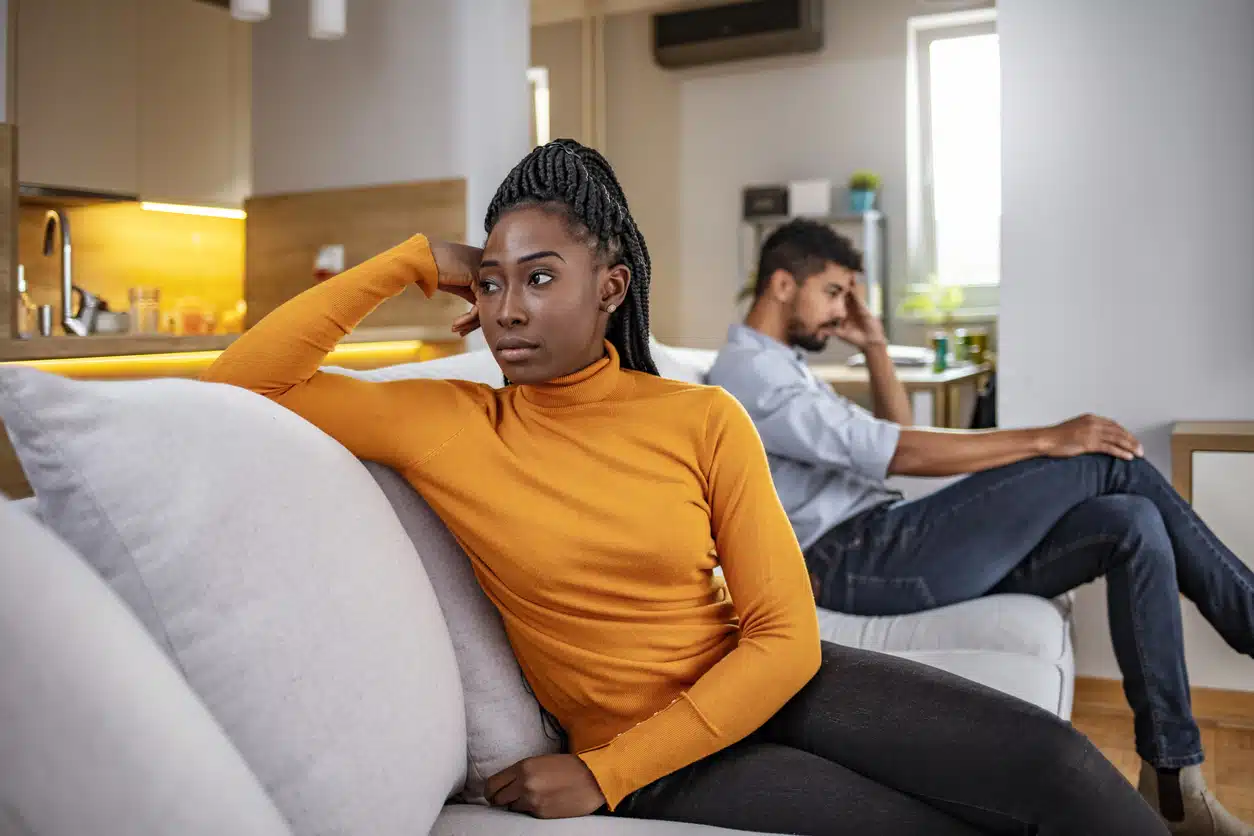 Unhappy couple giving one another the silent treatment after having an argument