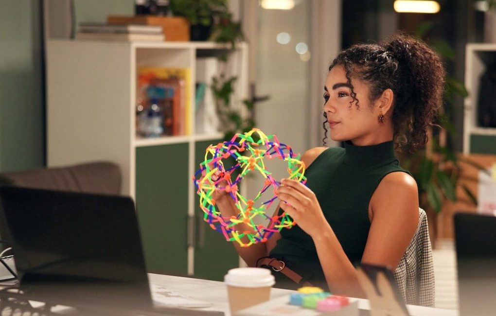 A neurodivergent person at their laptop at work