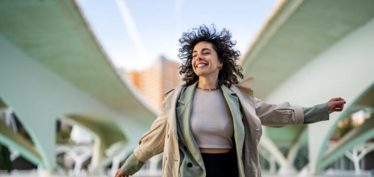 woman smiling and jumping in a positive mood