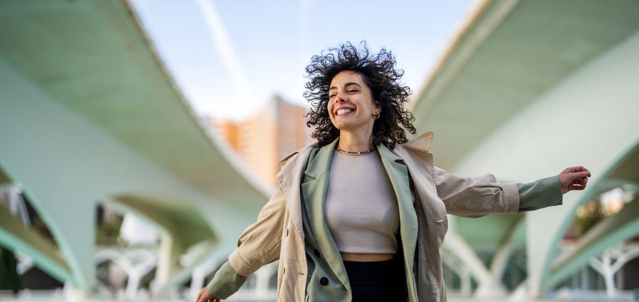 woman smiling and jumping in a positive mood