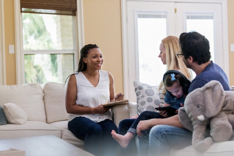 Social worker doing a home visit with a family