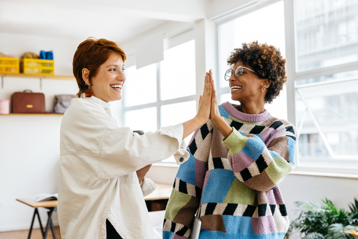 Colleagues celebrarting overcoming a stressfull sitatuation by being resilient