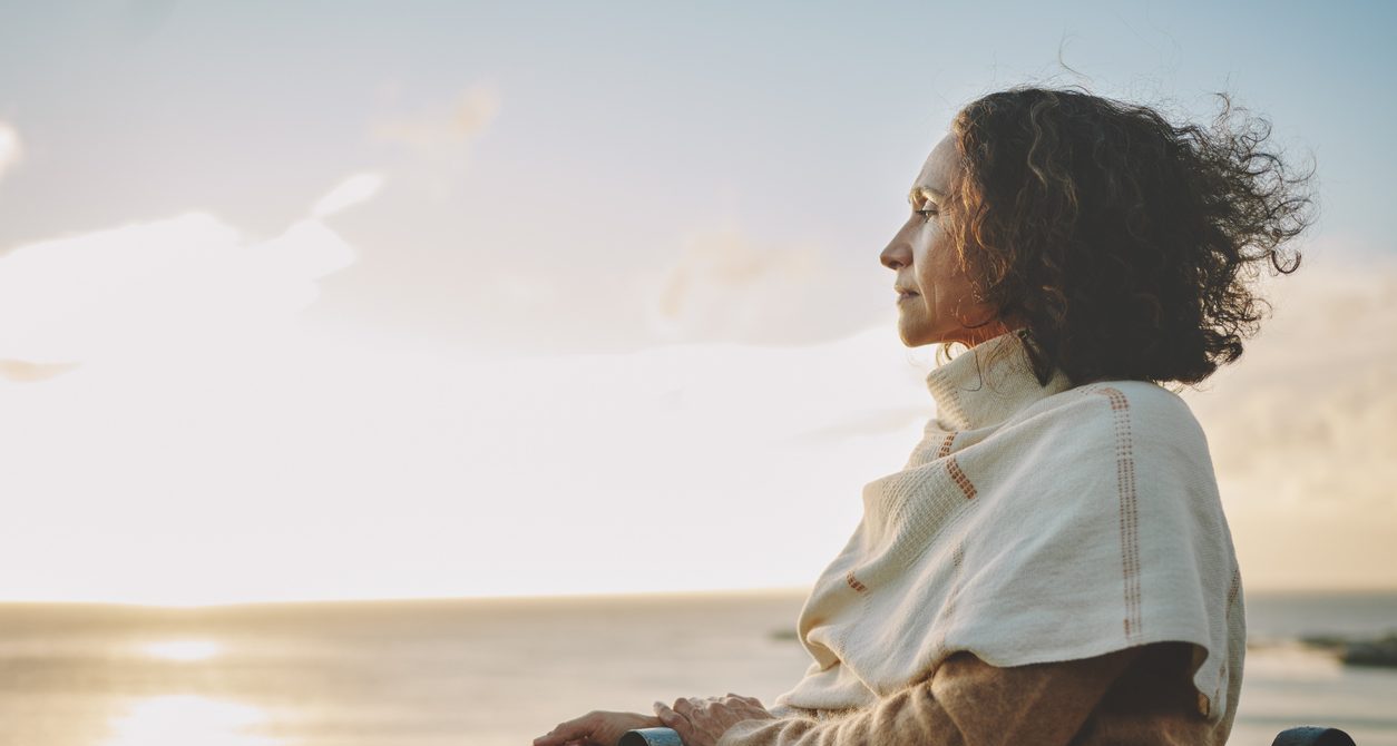 Woman at the beach during a sunset focusing on balance and introspection