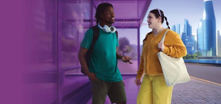 Two students talking at bus stop future city scape