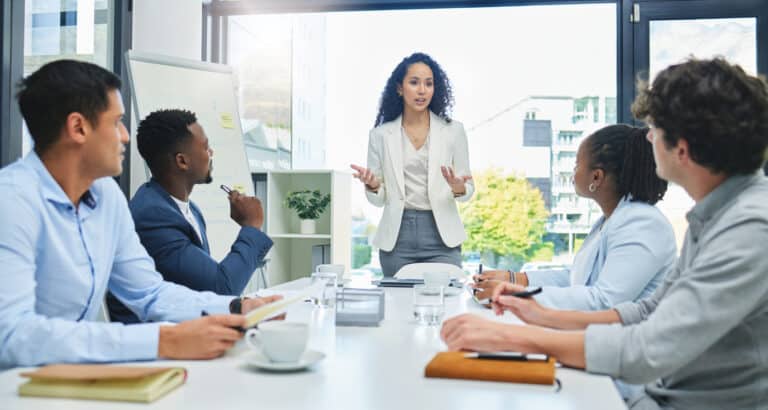 Young business woman who is a high achiever is busy in a meeting but has imposter syndrome that no one knows about